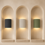 ArtiGlow ribbed wall lights in Grey, White and Green displayed in architectural niches